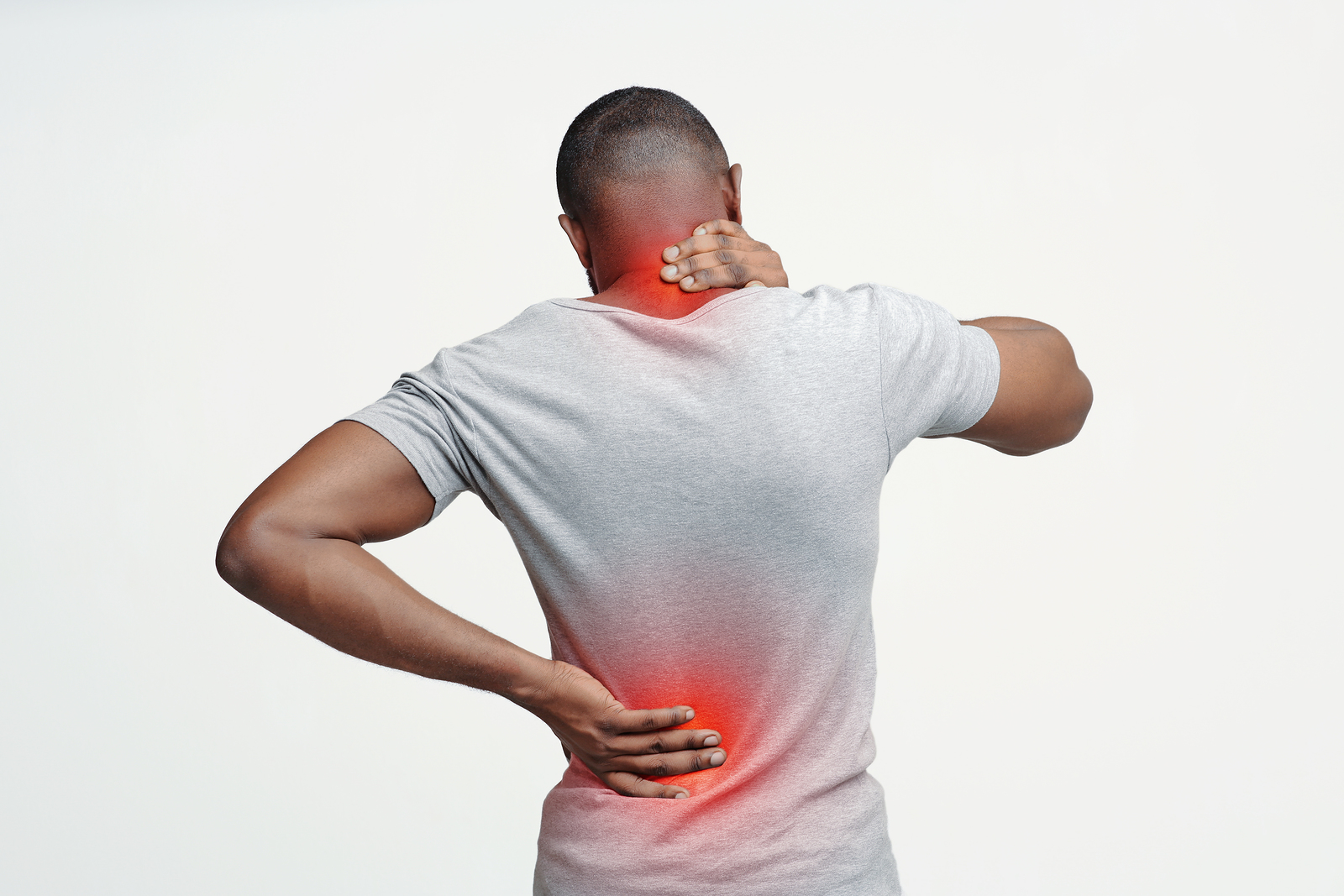 A man holding his neck and lower back in pain